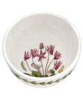 A white ceramic bowl featuring a classic botanical illustration of pink flowers and green leaves inside, with a matching leaf pattern around the outer rim, shown against a plain white background.