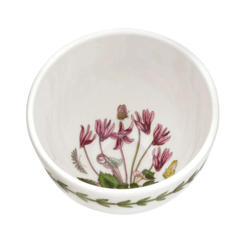 A white ceramic bowl featuring a classic botanical illustration of pink flowers and green leaves inside, with a matching leaf pattern around the outer rim, shown against a plain white background.