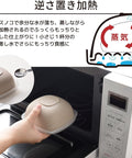 A beige dome-shaped silicone lid with a textured top is shown being held by a hand inside a white microwave, with Japanese text and a diagram explaining steaming heating.