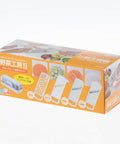 Japanese product packaging for a vegetable slicer set, featuring an orange box with illustrations of the slicer and sample cut vegetables, photographed on a white background.