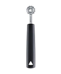 A kitchen tool with a black handle and a silver metal head, shown vertically on a plain white background. The handle has a triangular hole near the bottom and the metal shaft is branded with the text 'triangle'.