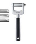 Triangle manual vegetable peeler with a black handle and silver metal body, shown with three interchangeable metal scraping attachments on a white background.