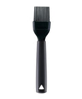 Black silicone and plastic pastry basting brush on a white background.