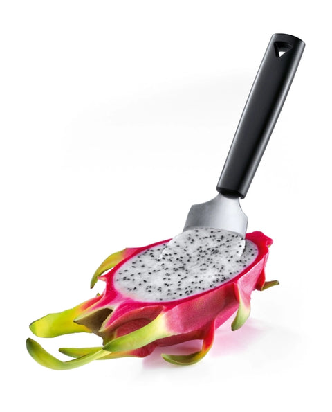 A kitchen utensil with a black handle and silver metal scoop, shown holding a sliced dragon fruit on a clean white background.
