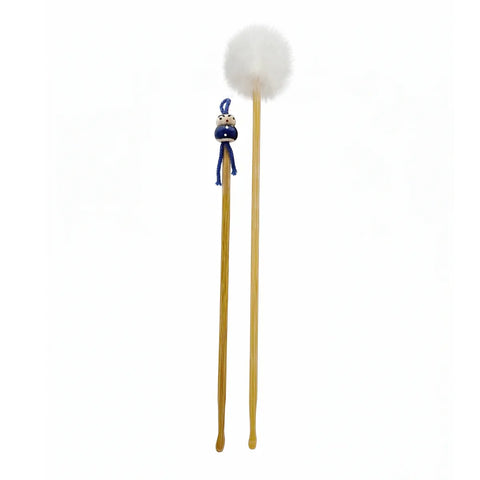 Two wooden ear picks with decorative ends on a white background