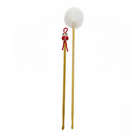 Two wooden ear picks with decorative ends on a white background