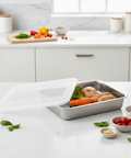Stainless steel food container with vegetables on a kitchen counter