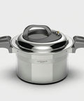 Stainless steel pot with lid on a light gray background
