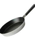 Black frying pan with a silver base on a white background