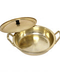 Gold-colored pot with lid on a white background