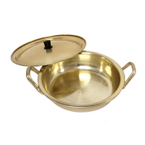Gold-colored pot with lid on a white background