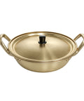 Gold-colored wok with lid on a white background