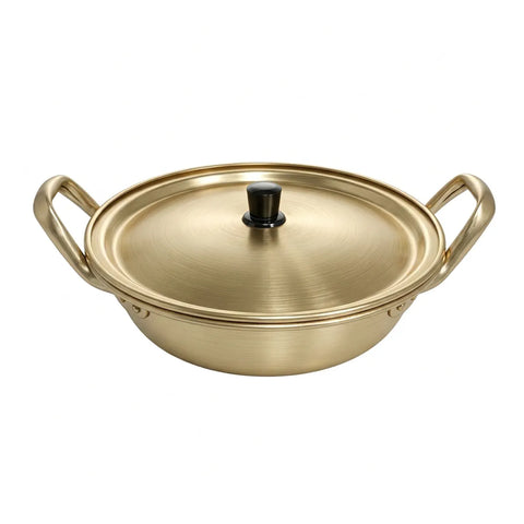 Gold-colored wok with lid on a white background