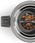 Stir-fry dish inside a pressure cooker lid on a white background