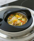 Stew with vegetables in a pressure cooker on a stove