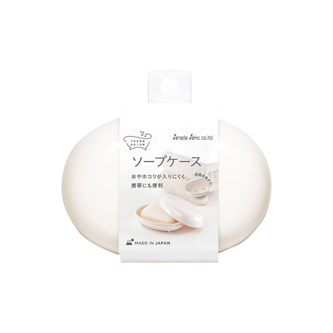 An oval-shaped white soap bar in a clear plastic case with a white paper label, shown on a plain white background. The label features Japanese text and the brand name 'Sanada Seiko Co. Ltd.'