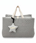 Gray quilted nap bag with a star-shaped pillow on a white background