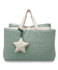 Green quilted nap bag with a star-shaped plush toy on a white background