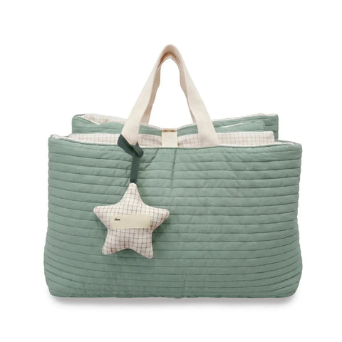 Green quilted nap bag with a star-shaped plush toy on a white background