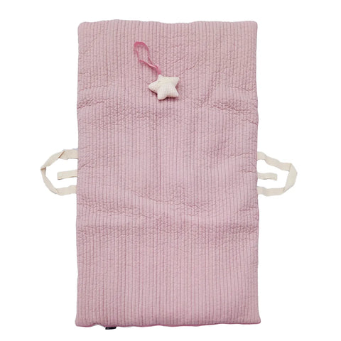 Pink quilted baby mat with star-shaped toy on a white background