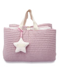 Pink quilted bag with a star-shaped toy on a white background