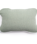 Textured green pillow on a white background