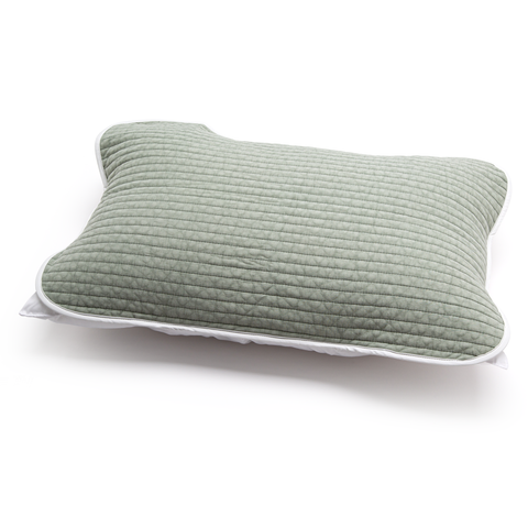 Green quilted pillow on a white background