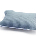 Blue quilted pillow on a white background