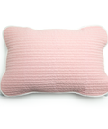 Pink textured pillow on a white background