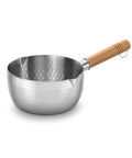 A stainless steel saucepan with a hammered finish and a light brown wooden handle, shown on a clean white background.