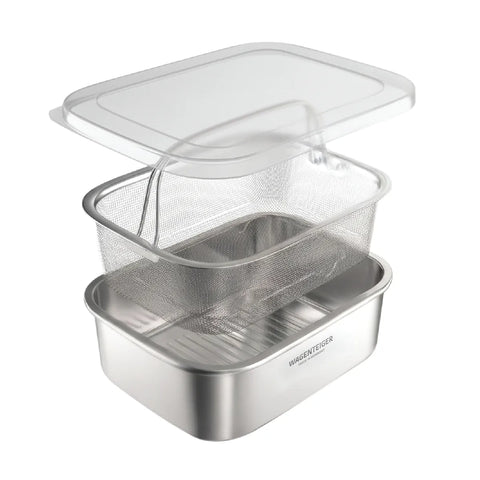 A stainless steel double-boiler steaming basket set with a clear plastic lid, shown on a clean white background.