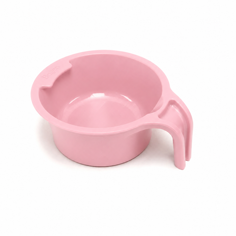 A light pink plastic measuring cup with a handle, shown on a clean white background.