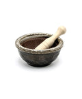 Ceramic mortar and pestle set on a white background