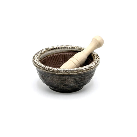 Ceramic mortar and pestle set on a white background