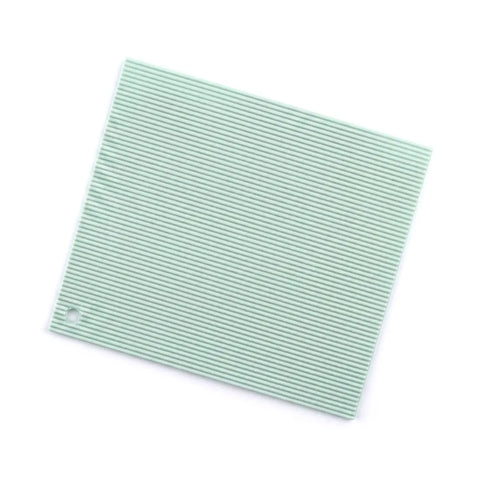 Green textured silicone square trivet on a white background