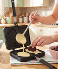 Person pouring batter in a taiyaki pan in a bright and colorful kitchen