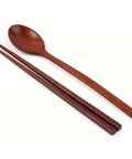 Wooden spoon and chopsticks on a white background