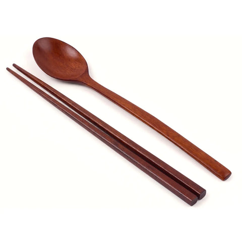 Wooden spoon and chopsticks on a white background