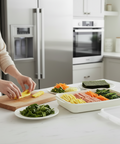 Person preparing food on a cutting board in a modern kitchen.