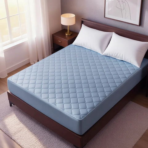 Blue mattress pad on a bed in a bedroom setting with a lamp and window.