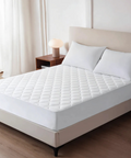 White mattress cover on a bed in a bedroom setting