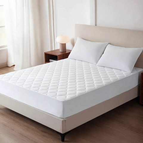 White mattress cover on a bed in a bedroom setting
