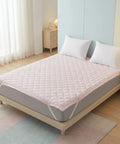 Mattress pad with a quilted cover in a bedroom setting