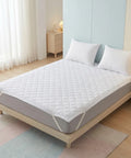 Mattress protector on a bed in a bedroom setting