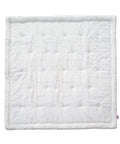 White quilted baby blanket on a white background