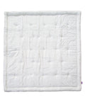 White quilted blanket on a white background