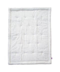 White quilted blanket on a white background