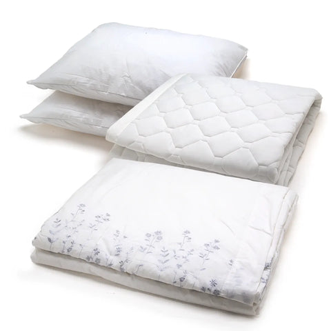 Three folded white bedding items stacked on a white background, including two pillows and a quilted mattress protector and comforter with a subtle floral pattern on the lower folded piece.