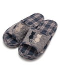 Pair of plaid slippers with cat designs on a white background