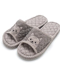 Pair of gray checkered slippers with cat face design on a white background